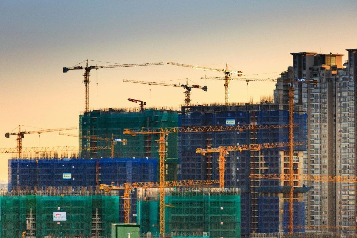 A construction site with cranes, an energy-intensive operation